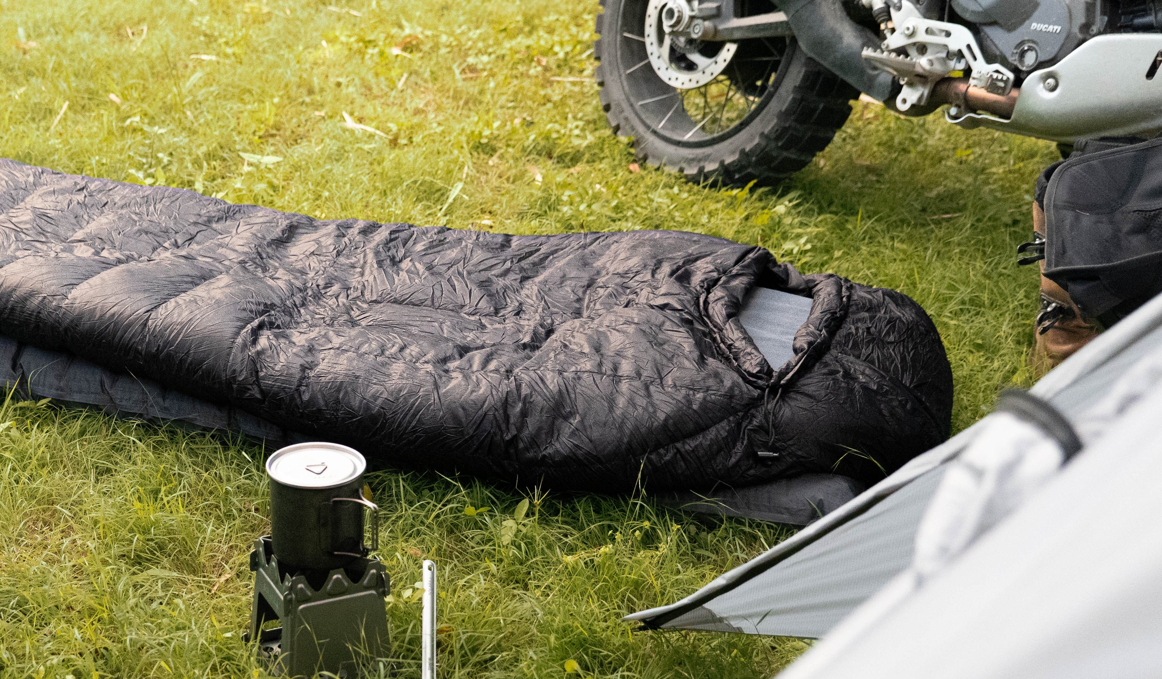 Motorcycle and sleeping bag on grass