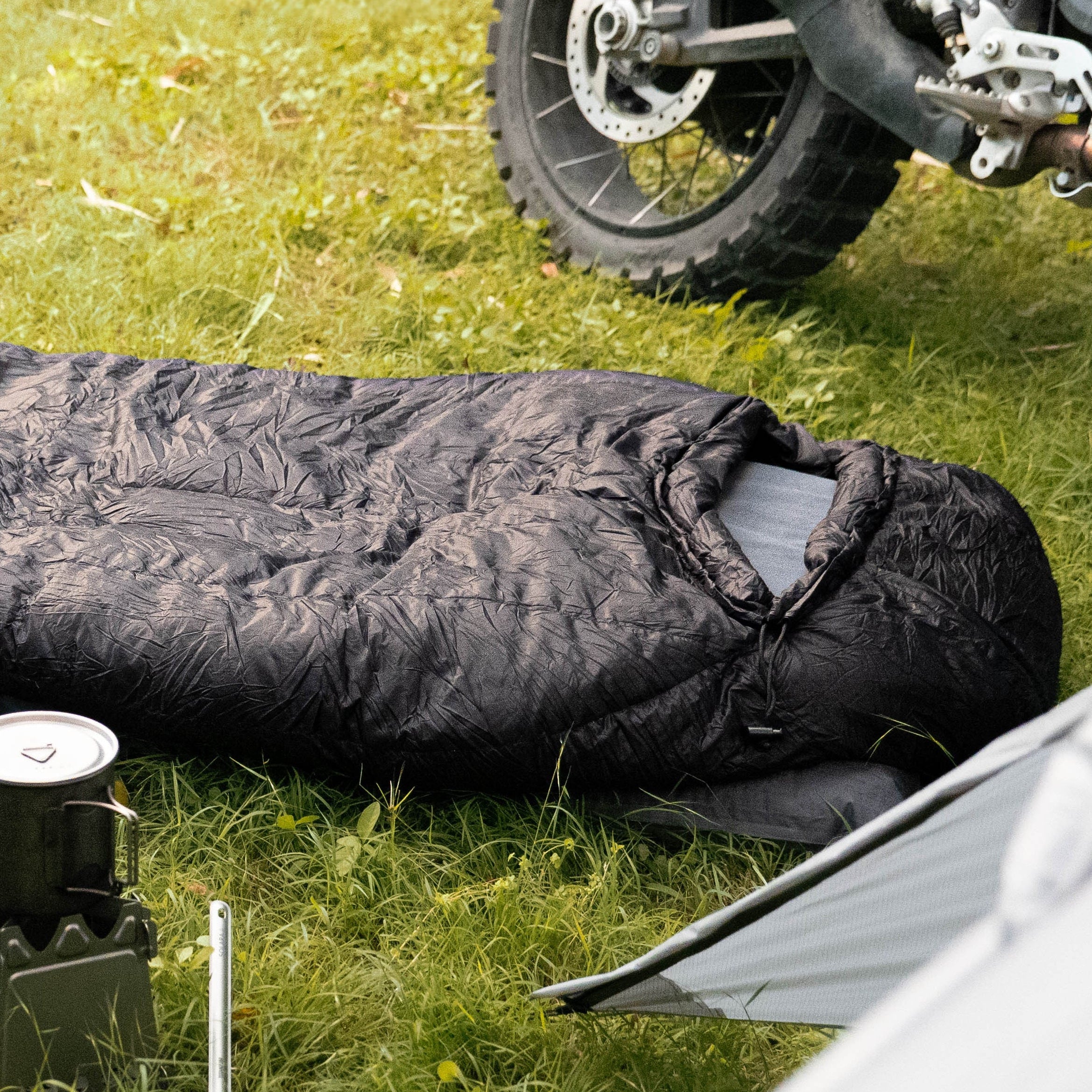 Motorcycle and sleeping bag on grass