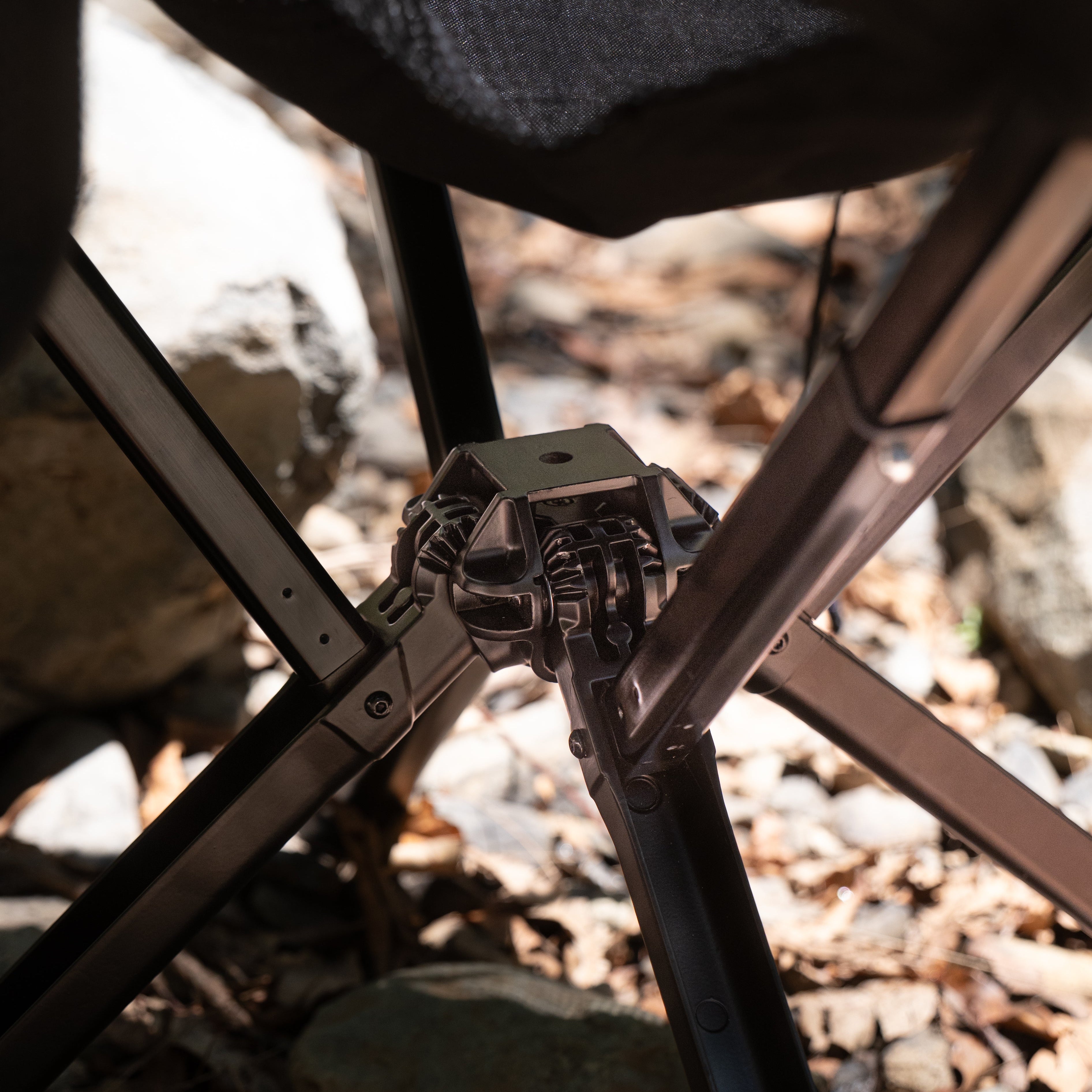 Close-up of a metal chair leg with a blurred natural background