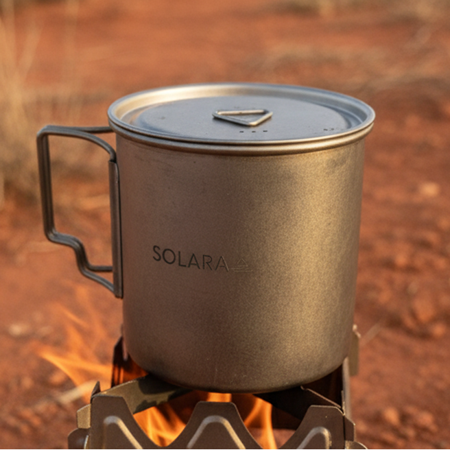 SOLARA mug on a portable stove with a motorcycle in the background