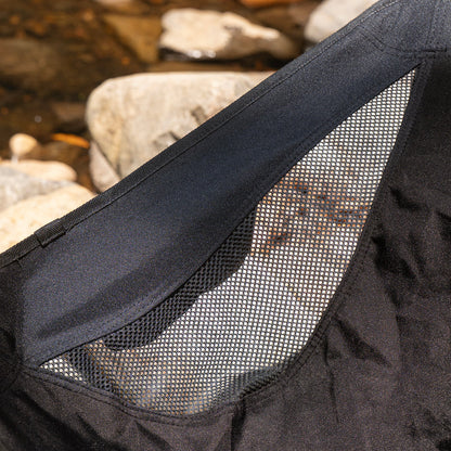 Close-up of a black bag with mesh side, natural stone background