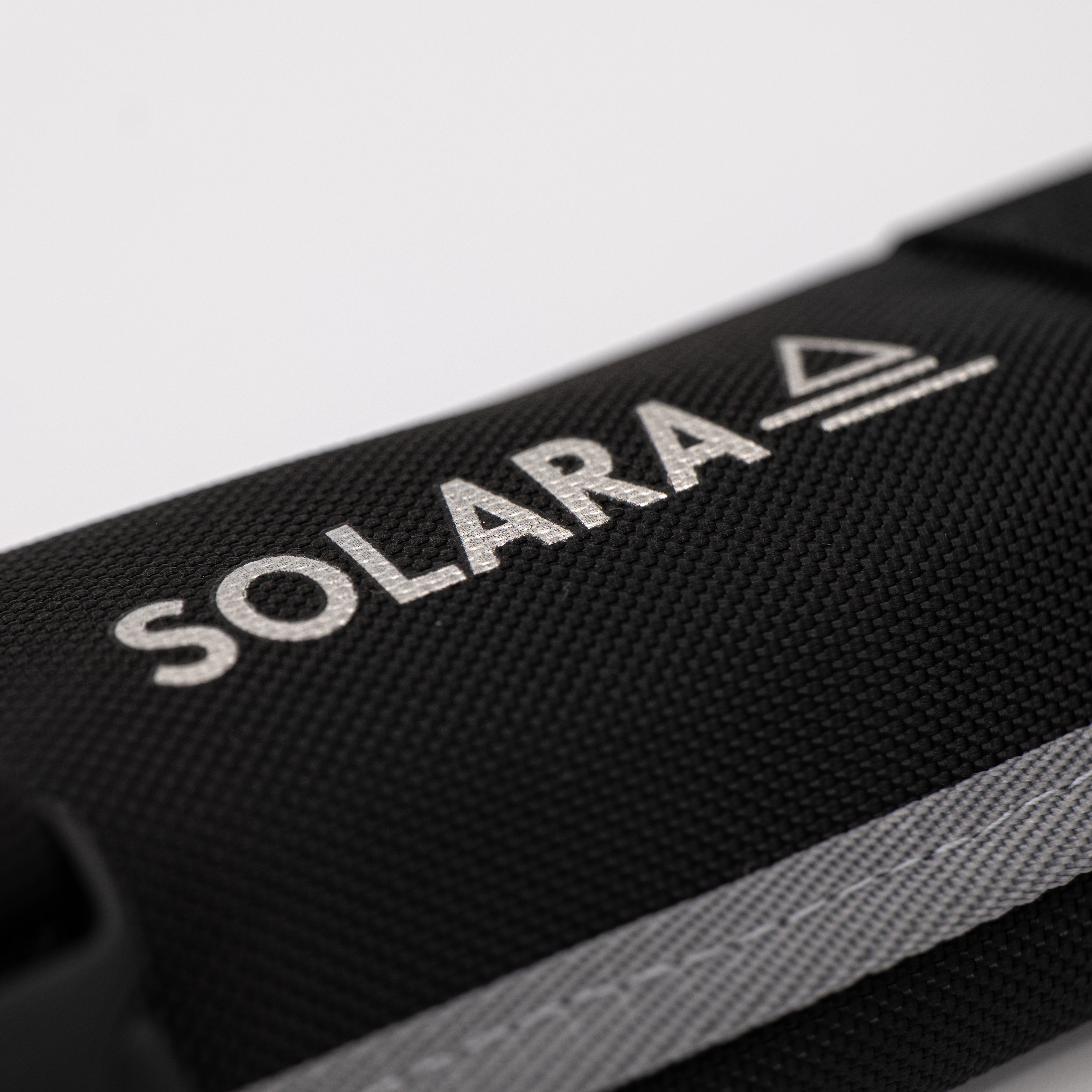 Black bag with 'SOLARA' logo on a light gray background